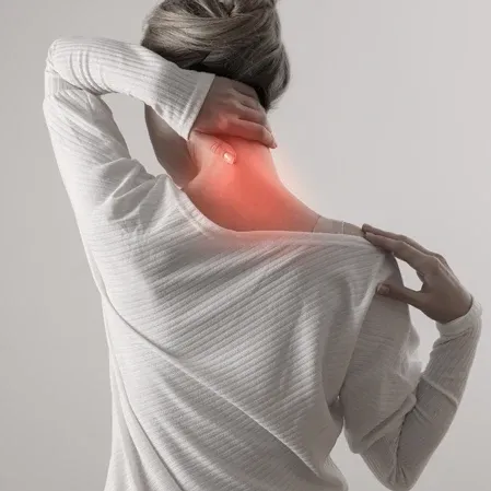 Person holding the neck with a highlighted pain area, representing cervical discomfort and musculoskeletal strain.
